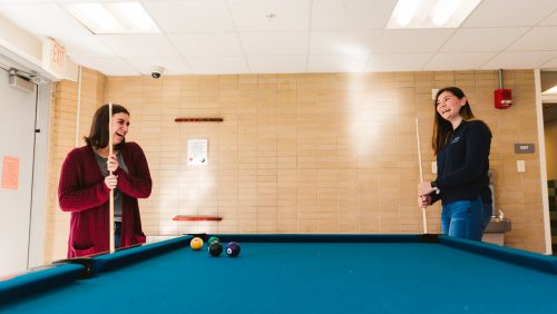 Students playing billiards at the dorm